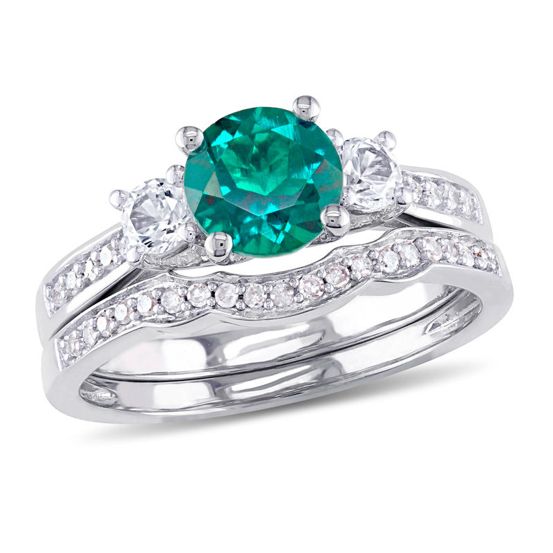 6.0mm Emerald and White Sapphire with 1/8 CT. T.W. Diamond Three Stone Bridal Set in 10K White Gold