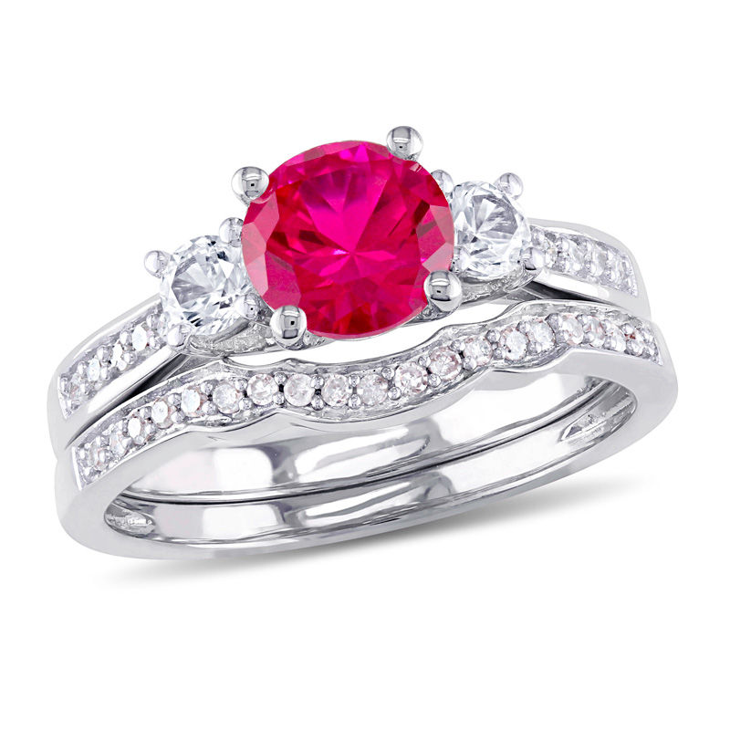 6.0mm Ruby and White Sapphire with 1/8 CT. T.W. Diamond Three Stone Bridal Set in 10K White Gold